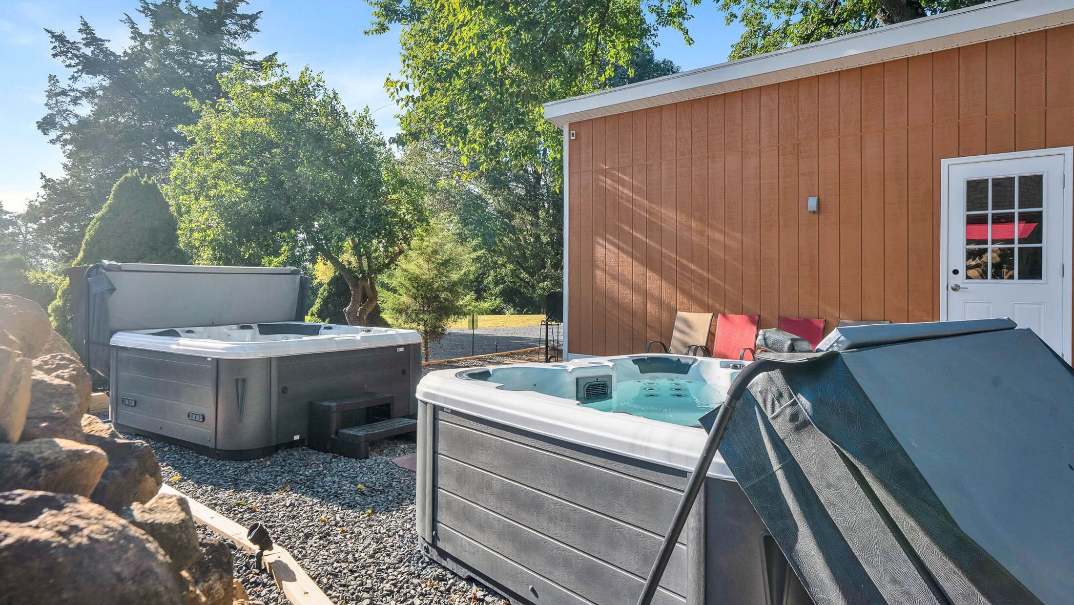 Two hot tubs outside of the sauna building at Chimney Hill Estate